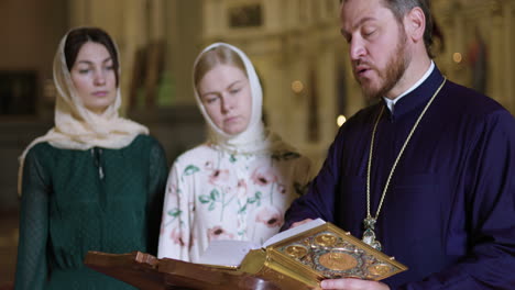 priest reading the holy book on the lectern