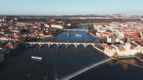 Cinematic-fly-over-Vltava-river-with-Charles-bridge-and-Prague-city-skyline