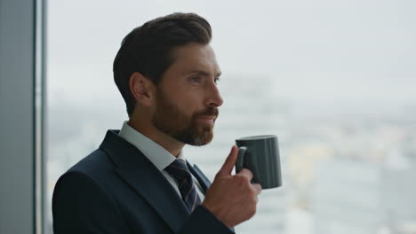 businessman having inspiration coffee break looking at cityscape close up.