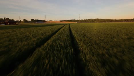 drone flies low over solar rows set in dark austrian soil at twilight