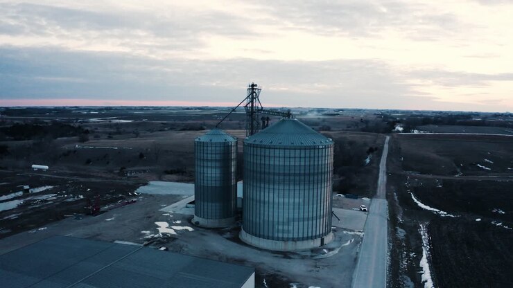 Orbiting aerial view of grain silos in rural Iowa
