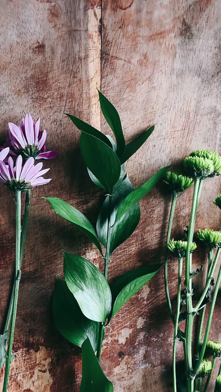 Beautiful Purple and Green Flowers on Wooden Background