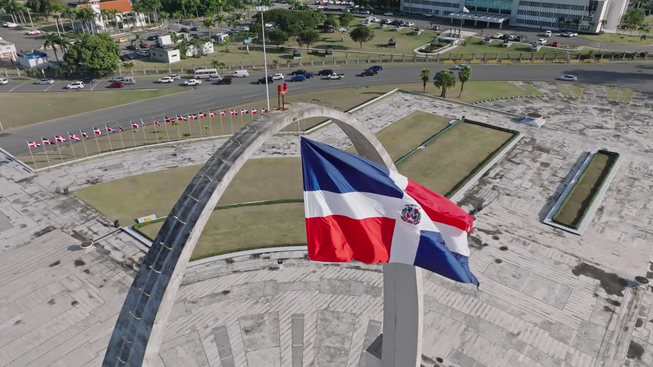 Aerial View Of Flag Square of Santo Domingo In The Dominican Republic Overlooking Daytime Traffic On The Road