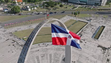 aerial view of flag square of santo domingo in the dominican republic overlooking daytime traffic on the road