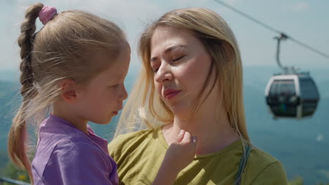 woman holds daughter listening to story at mountains resort