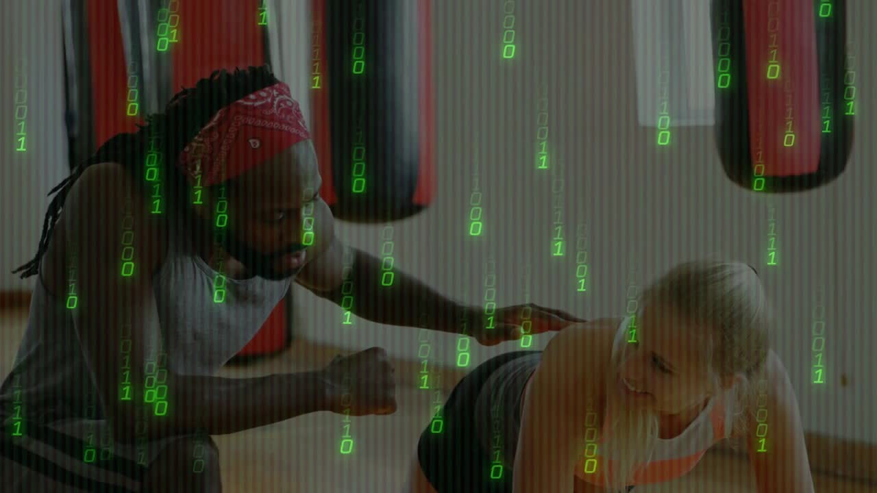 Fitnesstræner holder en høj planke ved en boksepude, mens træneren placerer hånden på hoften og kontrollerer kropsholdningen.