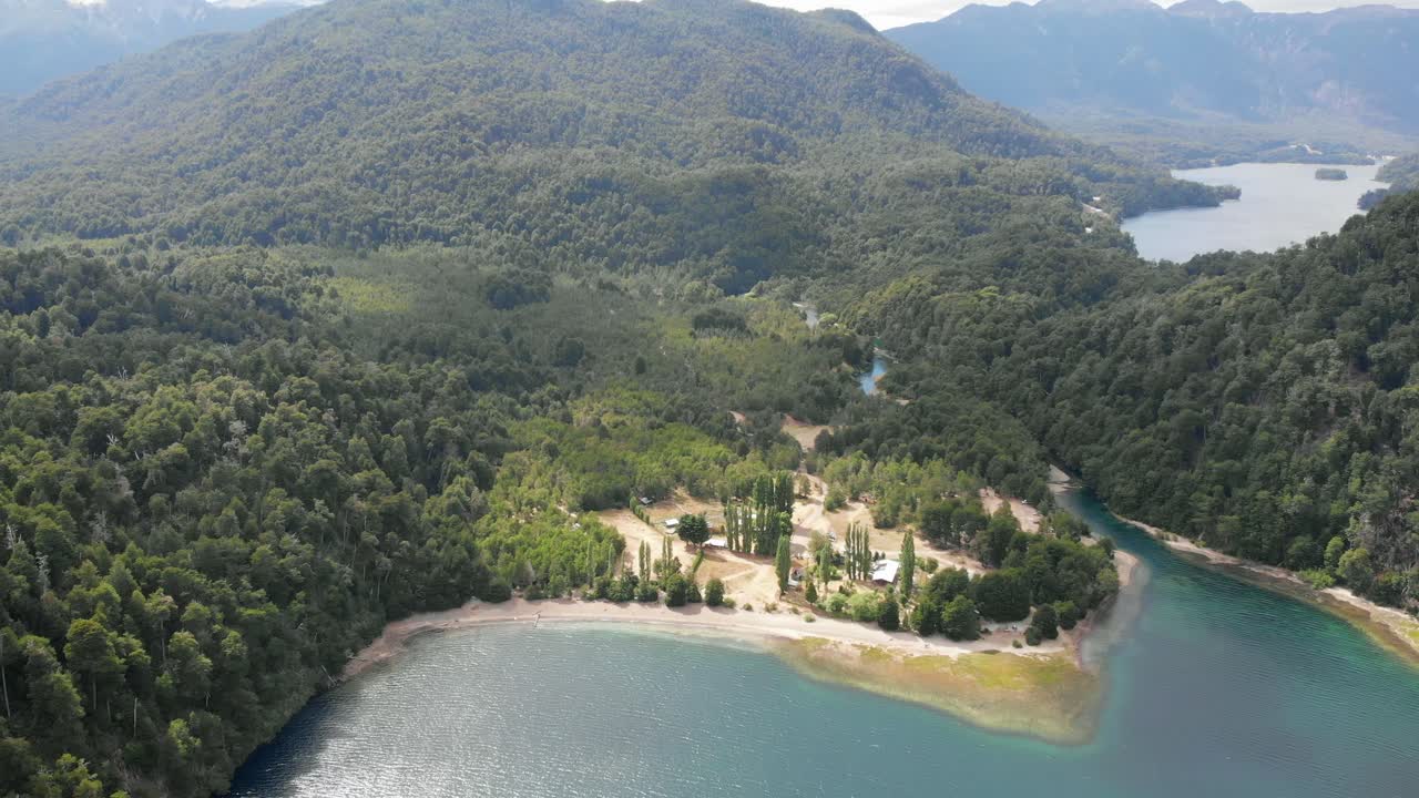 Rotating aerial reveals unspoiled mountain forest around Espejo Lake