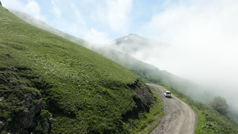 driving on the road at the mountain edge at tskhratskaro pass during misty morning in georgia