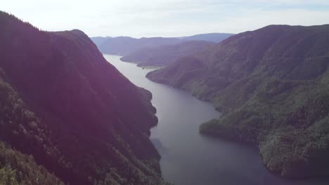 beautiful norway highland landscape, lake reveal from mountaintop forest, aerial
