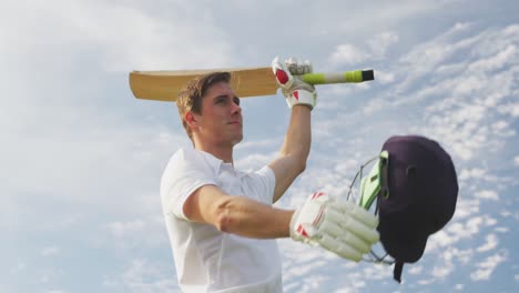 Low-angle-view-cricket-raising-his-hands-with-the-bat