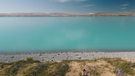 turquoise lake with mountains in the background