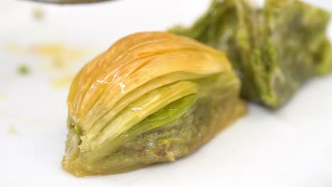 eating turkish baklava with pistachio, traditional dessert