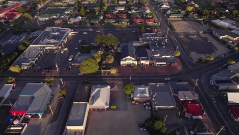 Aerial-sideways-main-street-of-a-small-town,-Saint-Helen,-Tasmania