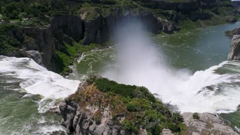 a 4k drone shot of shoshone falls, a raging waterfall, which often reflects rainbows, located along the snake river, only 3 miles away from perrine bridge and twin falls, idaho