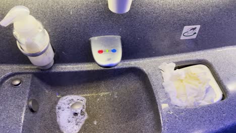 sanitizing and organizing airplane bathroom sink area