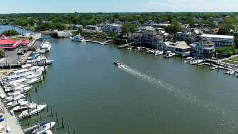 aerial slow motion small boat cruising down lewes canal, delaware