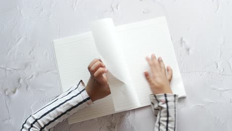 top view of child hand turning a pager of a diary