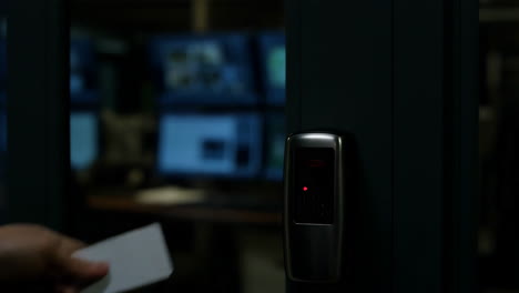 hand using key card for secure access at a data center or restricted area
