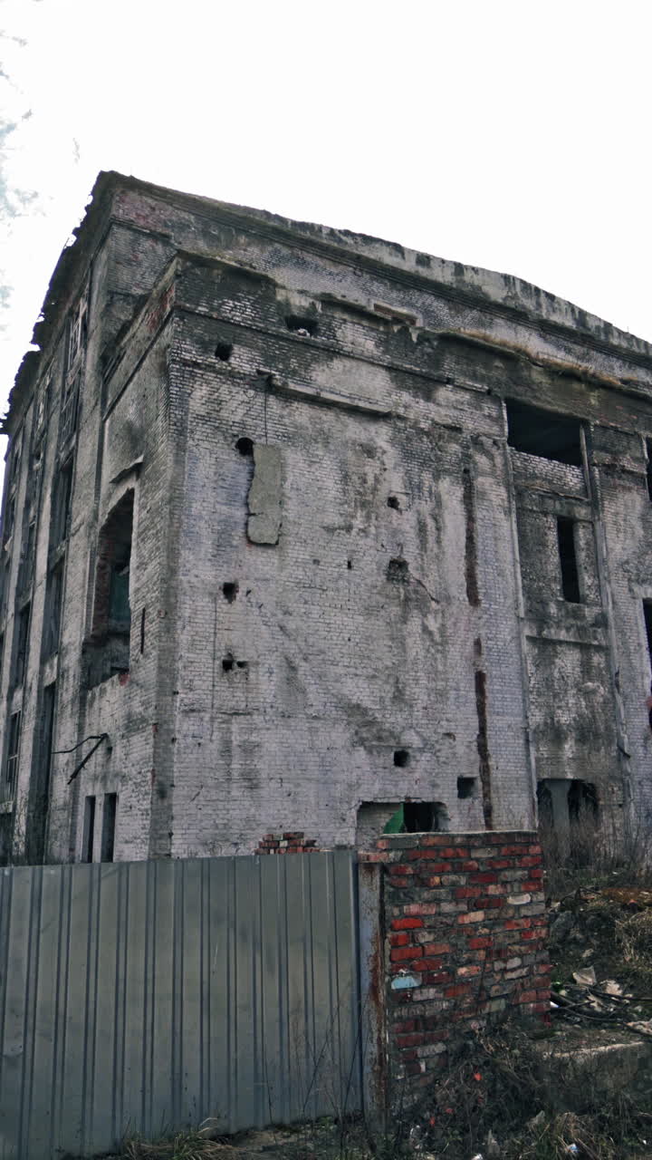 The ruins of the former factory. Ruined buildings in the city. Vertical video
