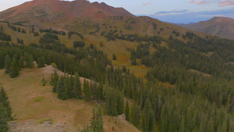 Aerial-in-the-Colorado-Rocky-Mountains-with-a-pan-left-to-reveal-sunset-over-the-mountains