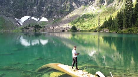 Man-operates-drone-over-Lake-Twentytwo,-capturing-inspiring-4K-footage-of-nature’s-beauty-in-Washington