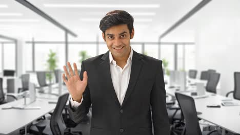 Happy-Indian-businessman-saying-Hi-and-waving-hand