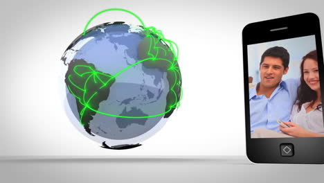 Video-of-couples-presented-on-smartphone-beside-globe