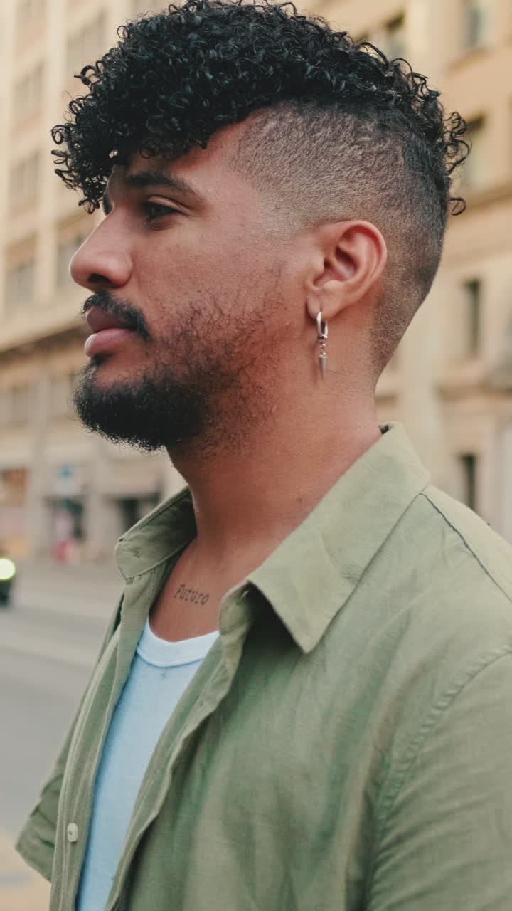 Portrait of a man with curly hair and beard outdoors
