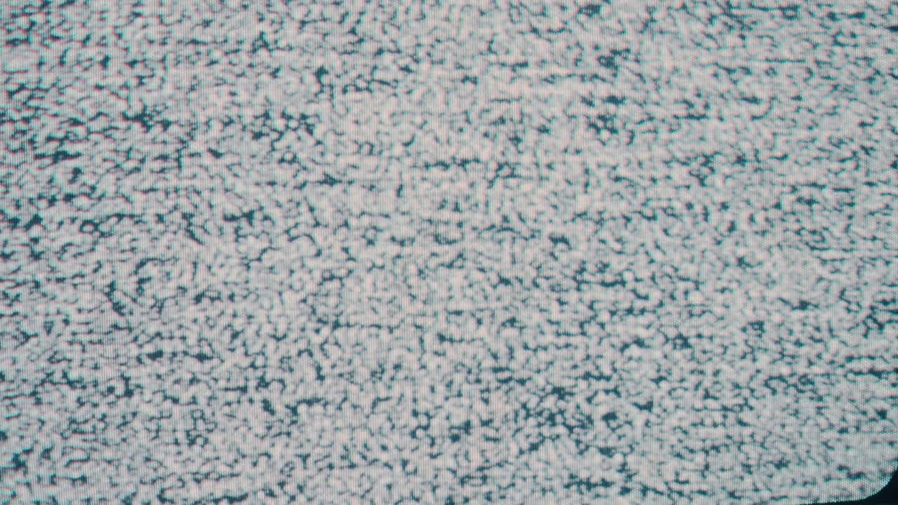 A close-up static shot capturing the iconic snow-like pattern of TV static noise