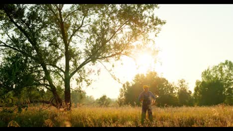 farmer in a field at sunset