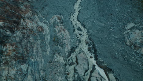 glacier melting in a lake below due to climate change in the alps, view from above