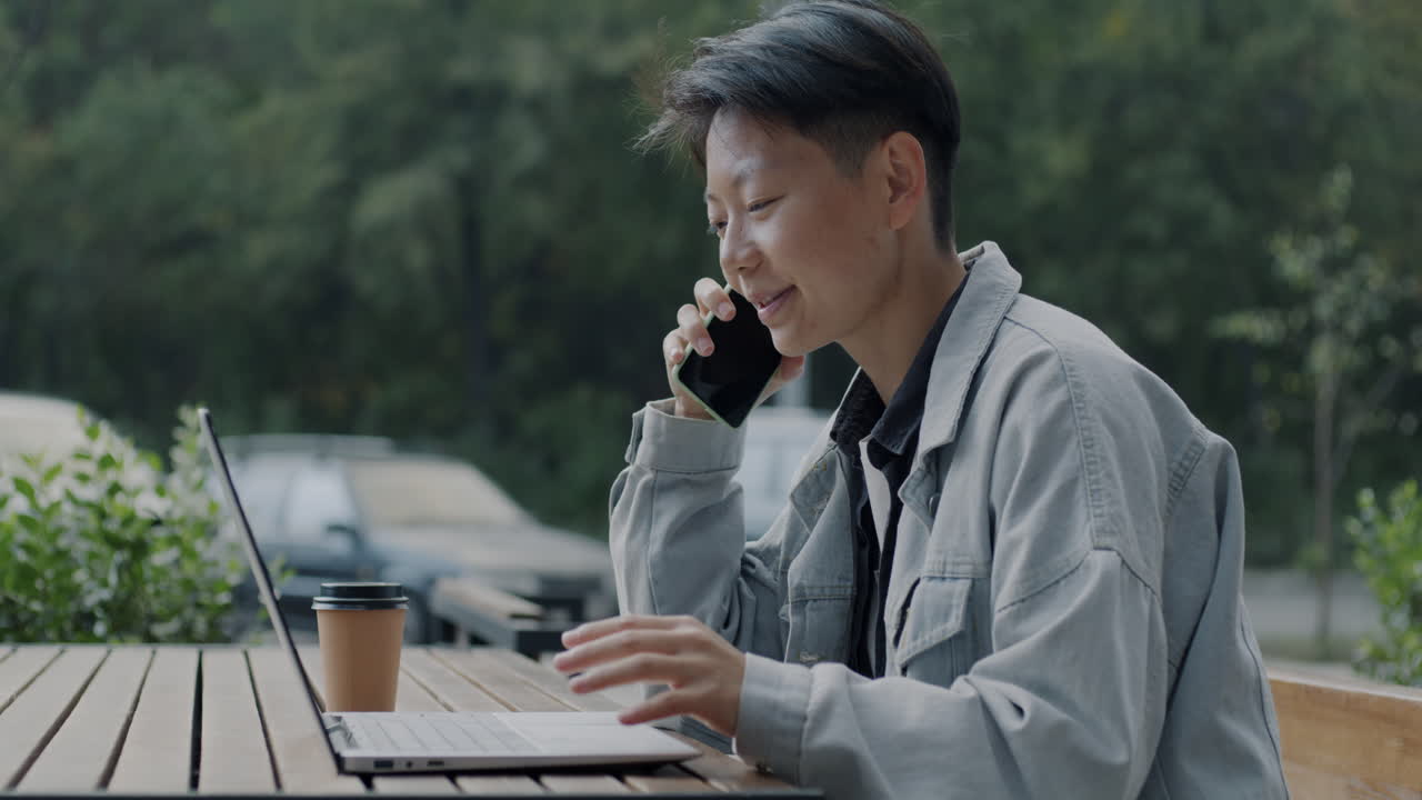 Young Person Working Outdoors at a Cafe
