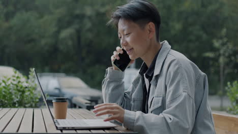 young person working outdoors at a cafe