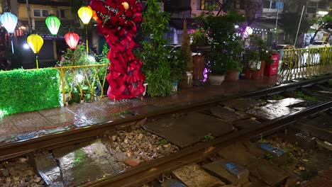 colorful decorations along railway tracks at night