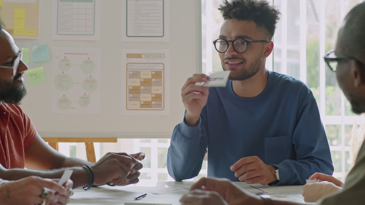 Young Male English Teacher Explaining New Words on Cards