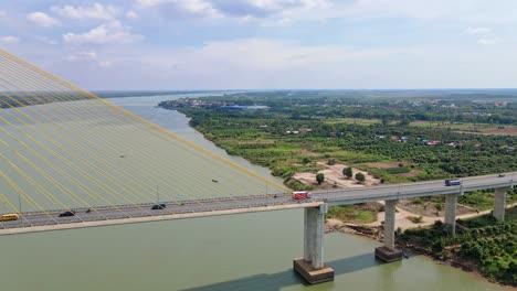 vehicles crossing mekong river through tsubasa bridge in neak loeung near phnom penh in cambodia