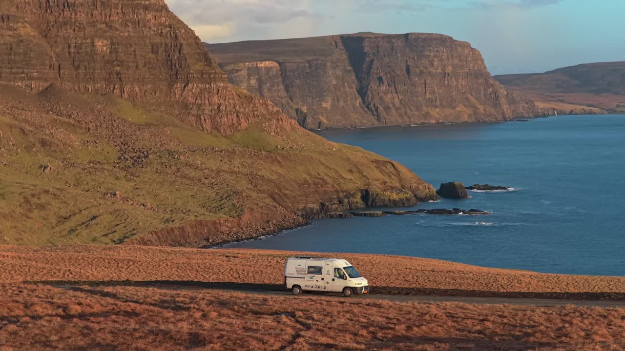Campervan driving along coastal road on isle of skye, scotland