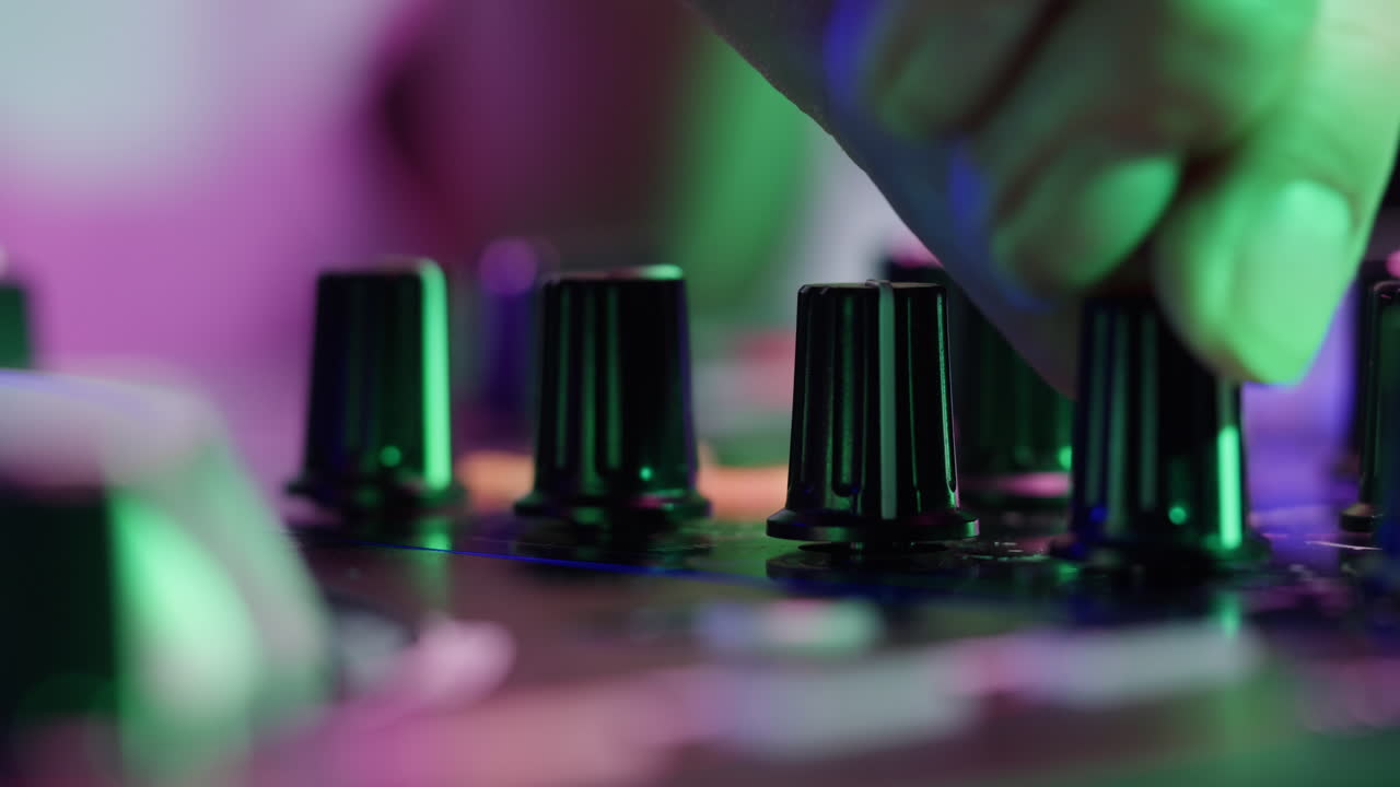 DJ with headphones and sunglasses playing music on festival in night club. Techno musician performing at nightclub for concert crowd of people, city bar.