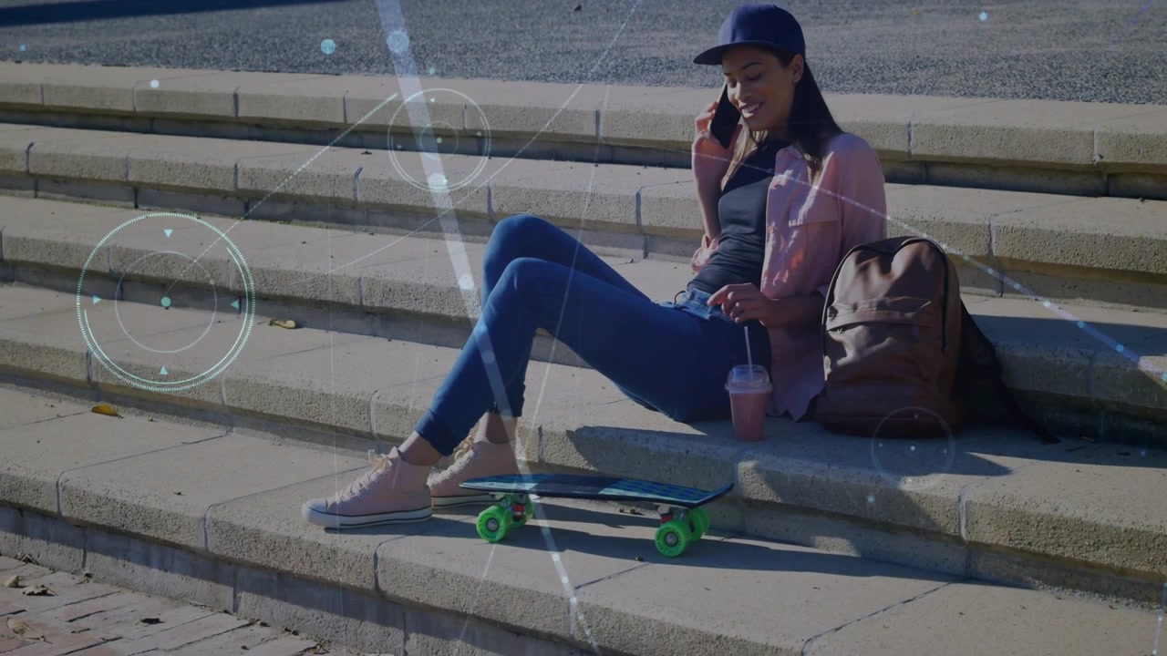 Woman sitting on steps raising phone and placing call, chatting while tech lens flares intensifying