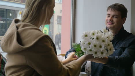 Man-Giving-Flowers-to-Woman