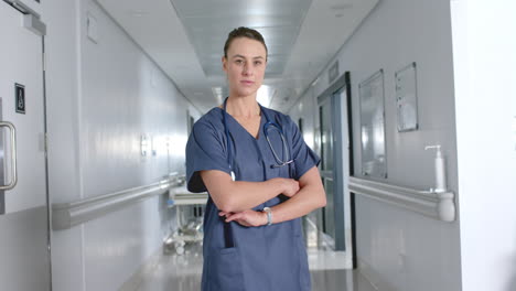 confident caucasian woman doctor stands in a hospital corridor