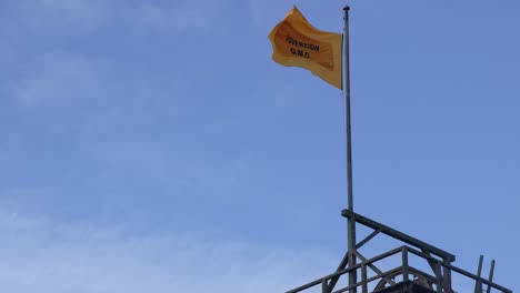 yellow flag waving atop a structure