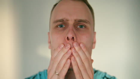 close up of man's face rubbing his cheeks in slow motion