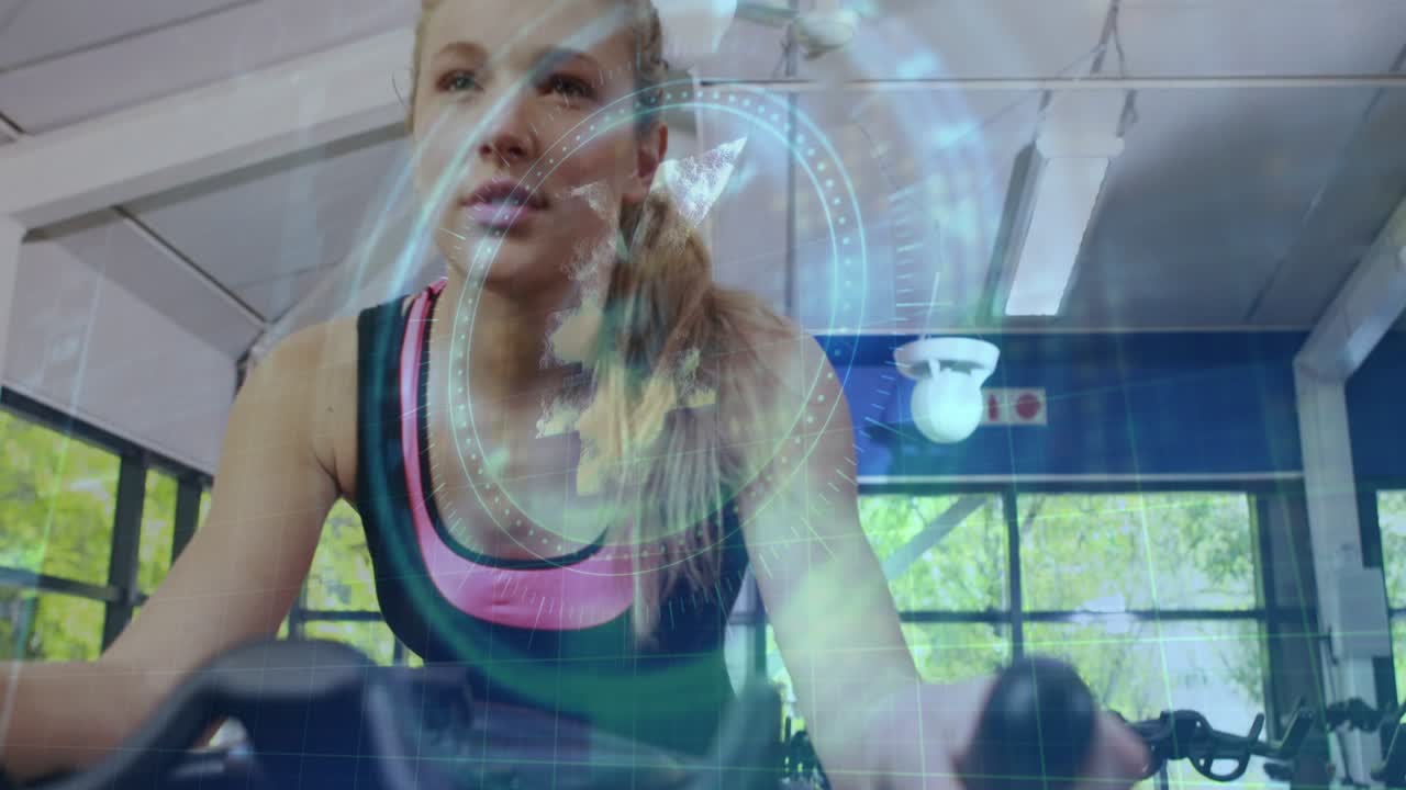 Woman tightening grip, pedaling on spin bike, initiating HUD overlay pulse for health monitoring