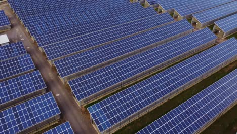 aerial footage of solar panel farm generating electricity from the sun