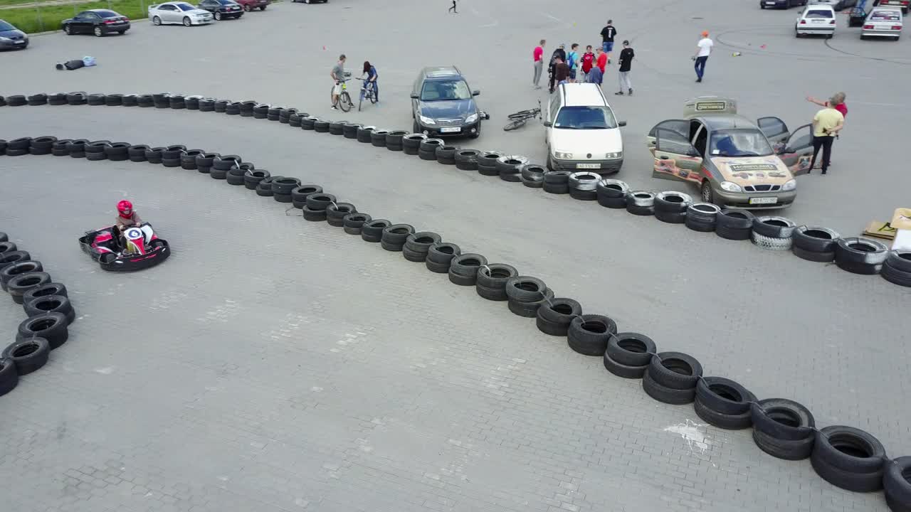 Driver In Helmet On Kart Circuit. VINNITSA, UKRAINE - MAY 2017: Europe Day, drivers in karts wearing helmet, racing suit participate in kart race