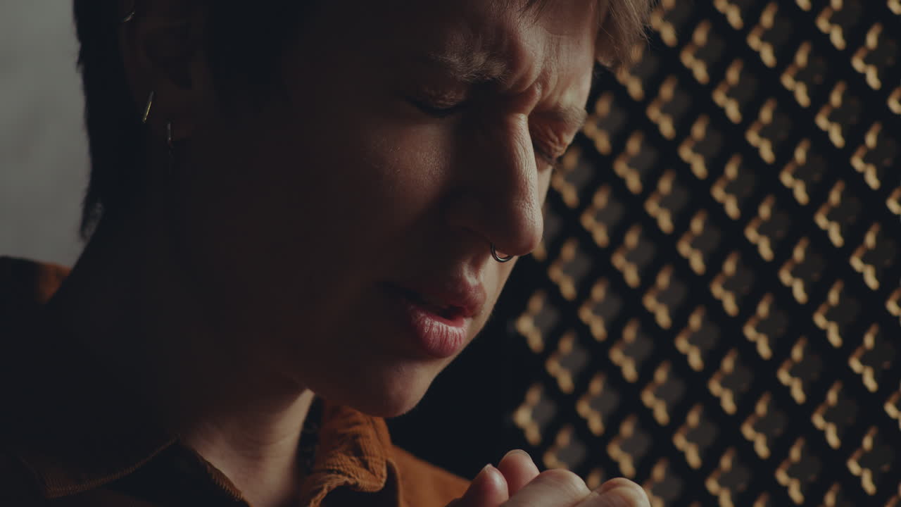 Young Woman Saying Contrition Prayer during Confession in Church