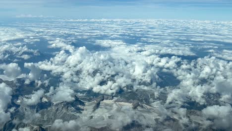 Aerial-view-taken-from-a-jet-cockpit-of-a-alpine-glacier-in-a-summer-day-with-almost-no-snow