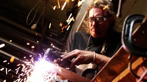 welder using welding torch