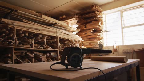 electric air blower on wooden plank in a carpentry shop